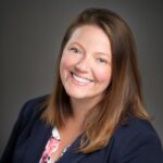 Woman with blue blazer smiling