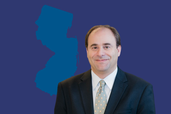 Photo of Gregg Indictor, YPTC Central New Jersey office Director in front of outline of New Jersey state, representing YPTC's nonprofit bookkeeping service and nonprofit accountants available throughout New Jersey